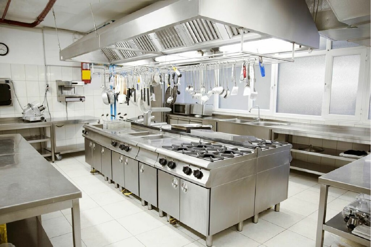 Efficient cloud kitchen with central cooking island, stainless steel equipment, and optimized layout for delivery operations