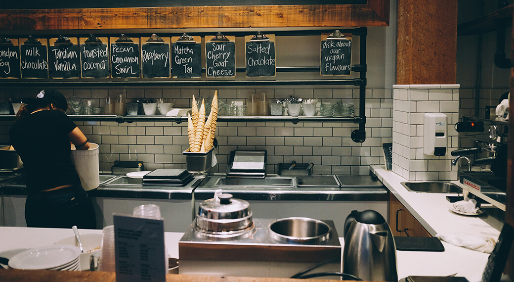 Cafe or small restaurant counter with subway tile backsplash, menu boards, and compact efficient setup